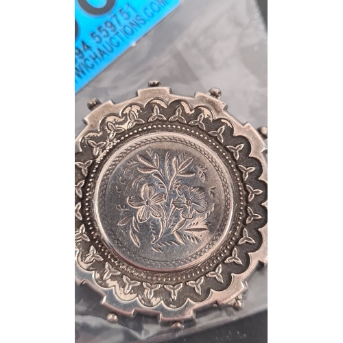 598 - Victorian white metal mourning brooch with floral design