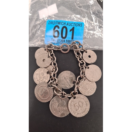 601 - White metal mixed coin bracelet. 6cm diameter