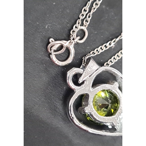 605 - Peridot stone with heart pendant on 925 silver chain. 44cm