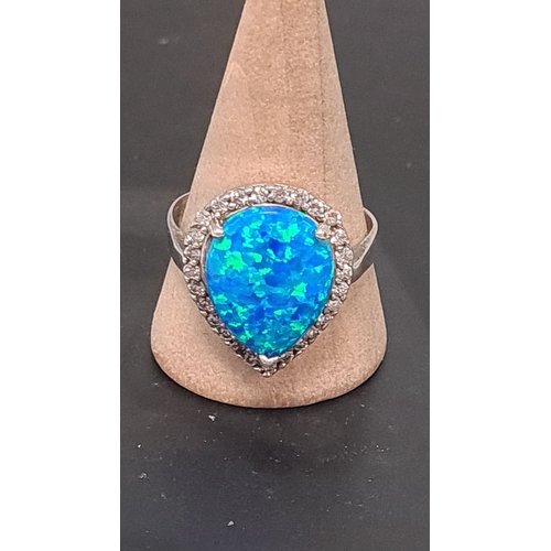 606 - white metal ring with teardrop blue opal style stone. Size U+