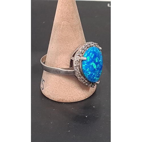 606 - white metal ring with teardrop blue opal style stone. Size U+