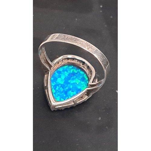 606 - white metal ring with teardrop blue opal style stone. Size U+