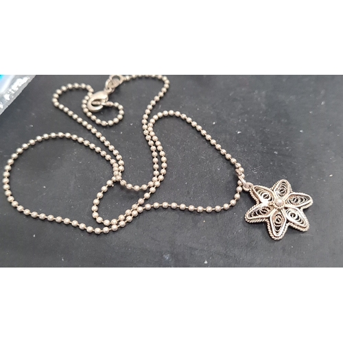 623 - 925 Silver chain with a filigree flower pendant. 40cm