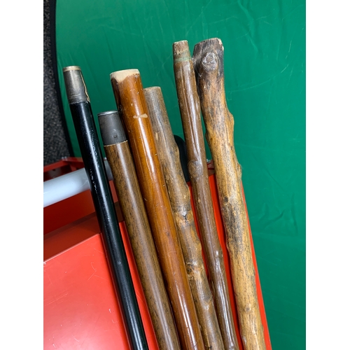 8 - Job lot of walking sticks, mainly wooden, one laminated with metal handle.