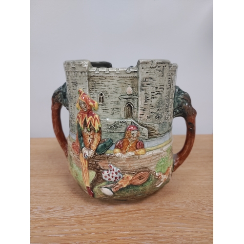 87 - 1934 Royal Doulton A Wandering Minstrel Loving Cup. H 14cm x W 17cm