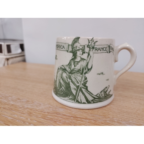 97 - 1919 Royal Doulton WW1 Victory and Peace mug. No 666159. H 7cm x W 9cm