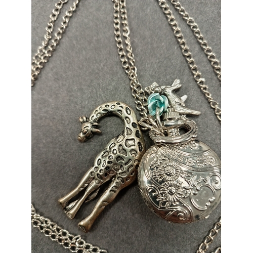 56 - White metal giraffe, fox pendants and pocket watch on long chain L 80cm