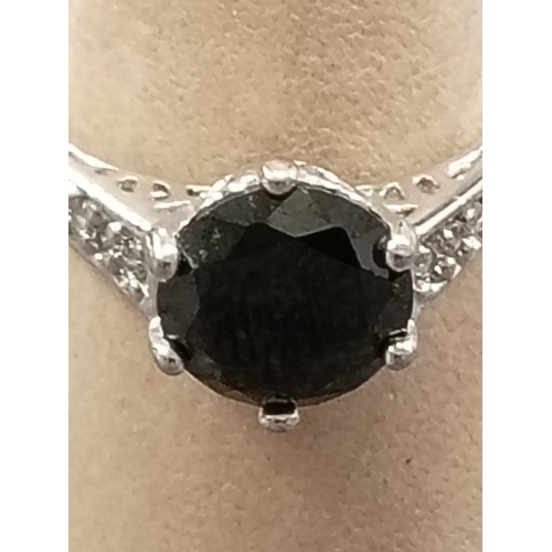 67 - 10kt marked white gold size P black large gemstone and clear gemstone ring weight 3.19 grams