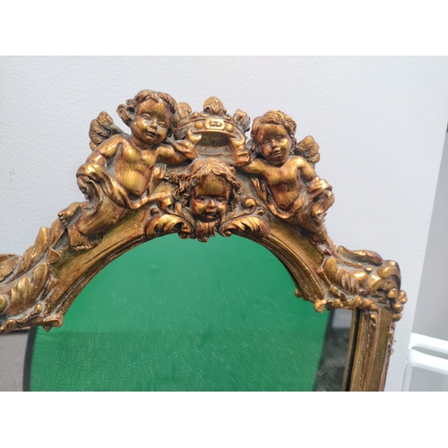 109 - Guilt gold framed mirror with cherubs holding a crown