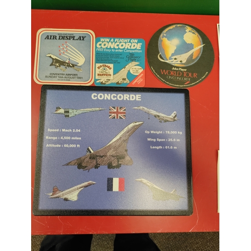 134 - Job lot of Concord memorabilia, including a pen, two badges, stamps, coasters, a mouse mat and a com... 