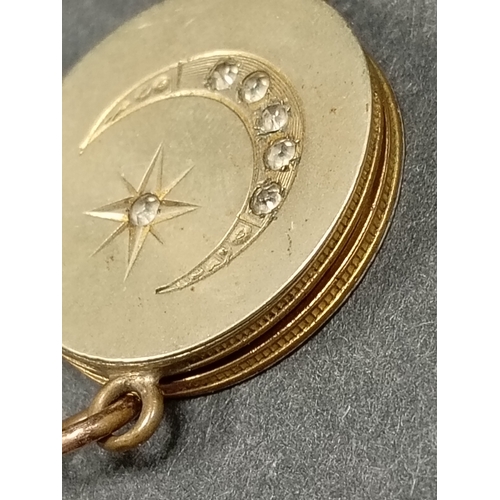 35 - Yellow metal round locket with moon and star diamanté detail measures 2cm