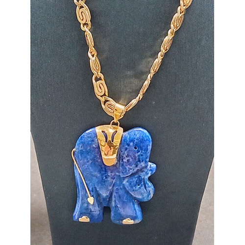 54 - Lapis lazuli Elephant pendant 3.5cm on a yellow metal chain 46cm