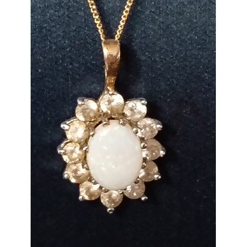 399 - 9ct gold opal and clear stone pendant on 9ct gold chain 40cm weight 1.68 grams