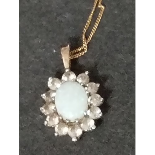 399 - 9ct gold opal and clear stone pendant on 9ct gold chain 40cm weight 1.68 grams