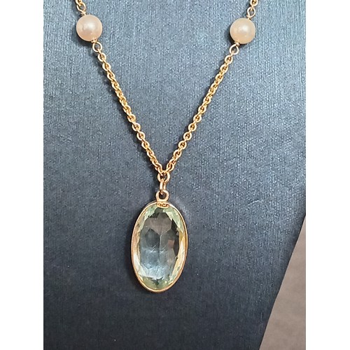 415 - 9ct gold large aquamarine coloured pendant on 40cm 9ct gold and faux pearl pendant 9.01 grams