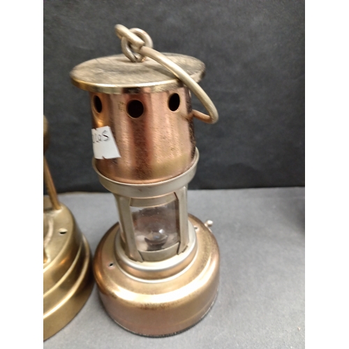 62 - A Cymru South Wales miners brass lamp H 21cm x W 8cm and a small copper and brass effect miners lamp... 