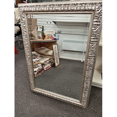 67 - Large ornate silver framed bevelled mirror H 110cm x W 80cm N