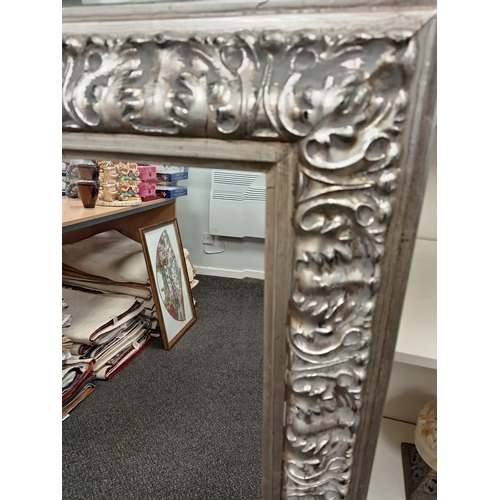 67 - Large ornate silver framed bevelled mirror H 110cm x W 80cm N