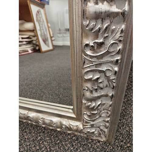 67 - Large ornate silver framed bevelled mirror H 110cm x W 80cm N