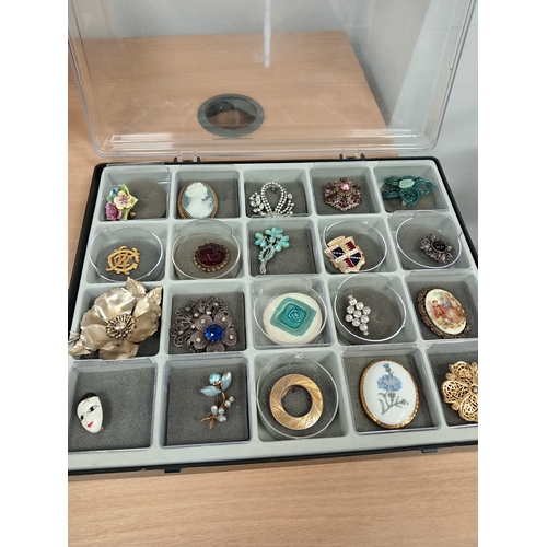 304 - Job lot of vintage brooches and scarf clips in an A/F display case