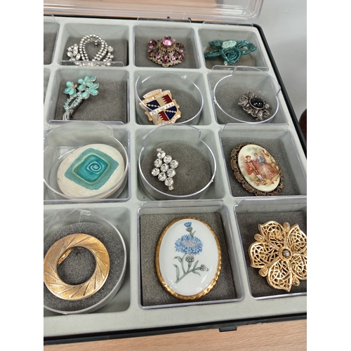 304 - Job lot of vintage brooches and scarf clips in an A/F display case