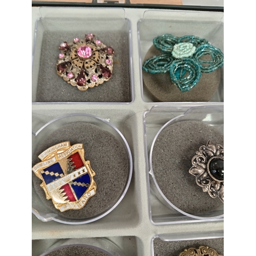 304 - Job lot of vintage brooches and scarf clips in an A/F display case