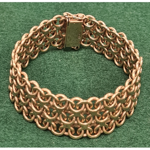 323 - 9 carat gold wide lace weave style bracelet marked 375. 5.5cm in diameter 35.6 grams