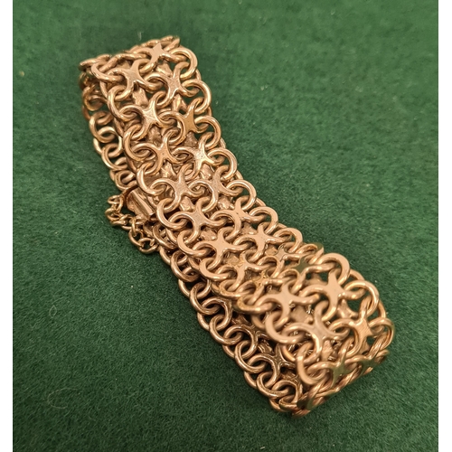 323 - 9 carat gold wide lace weave style bracelet marked 375. 5.5cm in diameter 35.6 grams