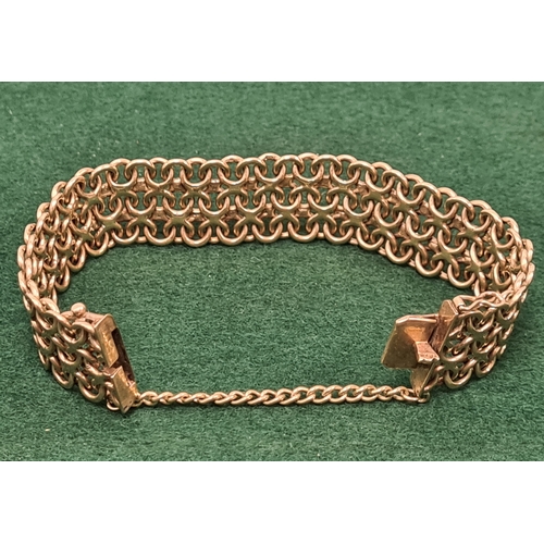 323 - 9 carat gold wide lace weave style bracelet marked 375. 5.5cm in diameter 35.6 grams