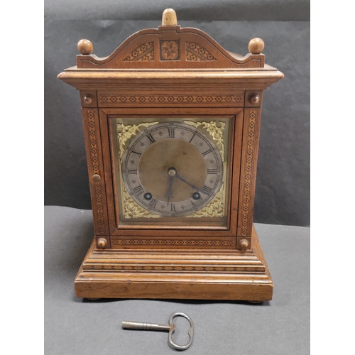 405 - Antique Oak In layed Mantel Clock complete with pendulum and key.