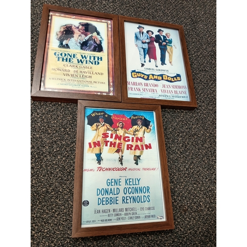 415 - Three vintage classic movie posters in wooden frames includes Gone with the wind, Guys and dolls and... 