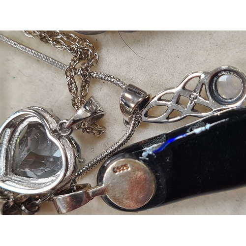 656 - Collection of 12 good quality Silver pendants, 9 with chains. Includes one locket.