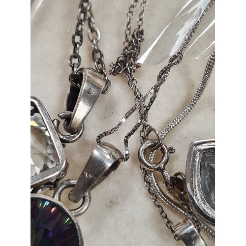 656 - Collection of 12 good quality Silver pendants, 9 with chains. Includes one locket.