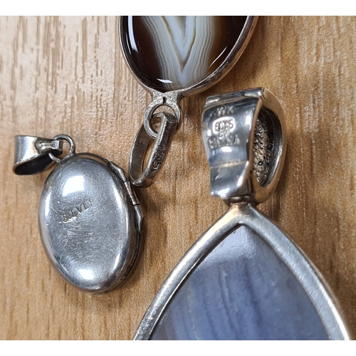 656 - Collection of 12 good quality Silver pendants, 9 with chains. Includes one locket.