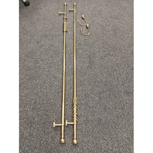 421 - Pair of brass curtain eyelet poles each measure 150cm with one set of matching tiebacks