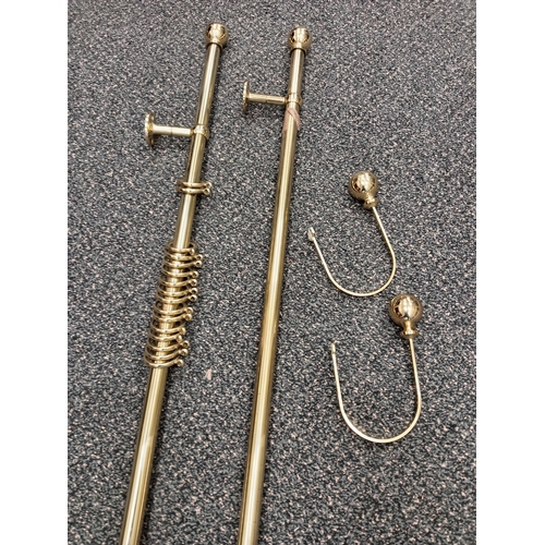 421 - Pair of brass curtain eyelet poles each measure 150cm with one set of matching tiebacks