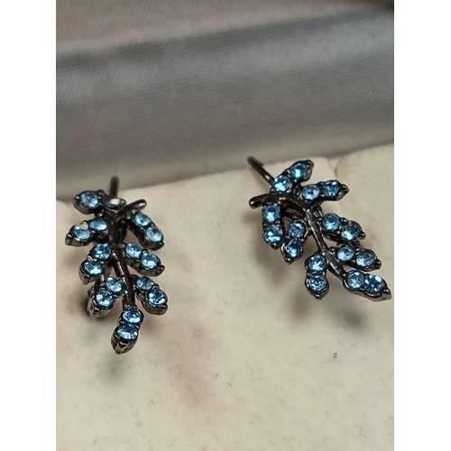 685 - White metal lever back leaf earrings with blue stones