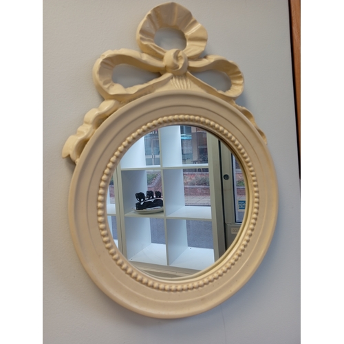 475 - Round cream mirror with ribbon detail measures H 44cm x W 33cm