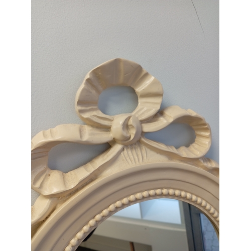 475 - Round cream mirror with ribbon detail measures H 44cm x W 33cm