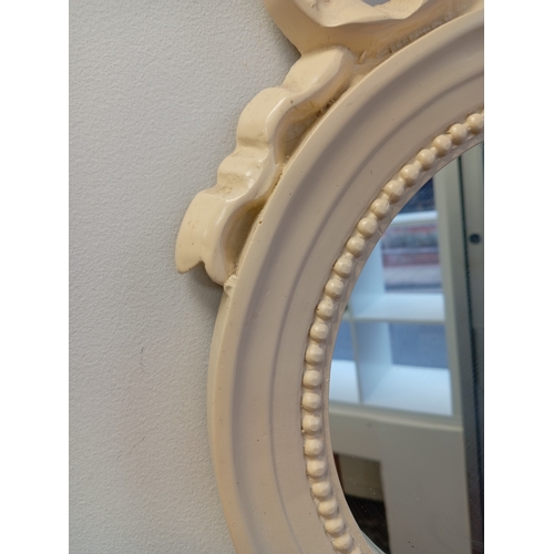 475 - Round cream mirror with ribbon detail measures H 44cm x W 33cm