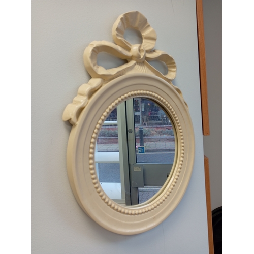 475 - Round cream mirror with ribbon detail measures H 44cm x W 33cm