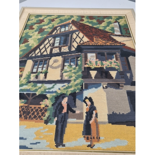 491 - Framed Cross Stitch Tapestry old style timbered house scene. H57cm x 44cm