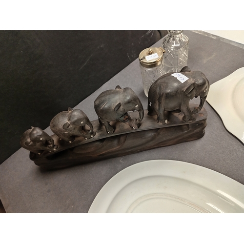 531 - Ebony carved herd of elephants sculpture A/F repair on one leg, two silver plated topped glass condi... 