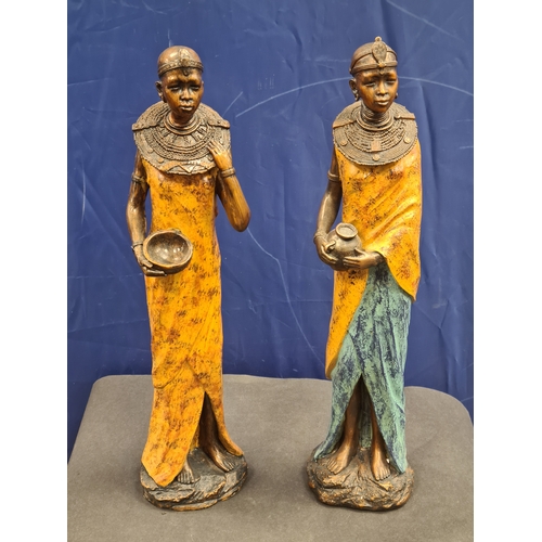 534 - A Pair of tall cast resin African lady figures in decorative native costume. One AF on head band, bo... 