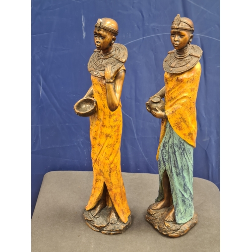 534 - A Pair of tall cast resin African lady figures in decorative native costume. One AF on head band, bo... 