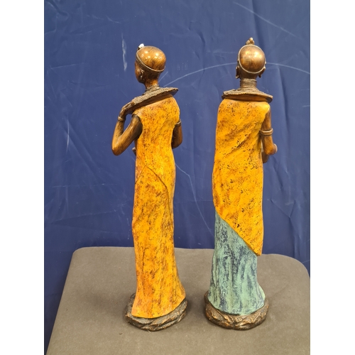 534 - A Pair of tall cast resin African lady figures in decorative native costume. One AF on head band, bo... 