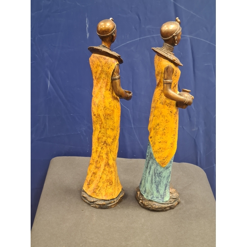 534 - A Pair of tall cast resin African lady figures in decorative native costume. One AF on head band, bo... 