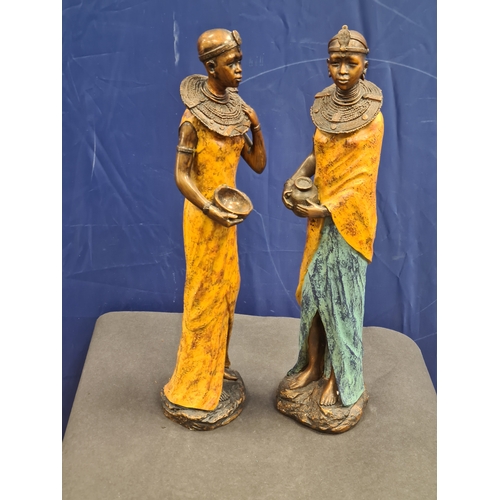 534 - A Pair of tall cast resin African lady figures in decorative native costume. One AF on head band, bo... 