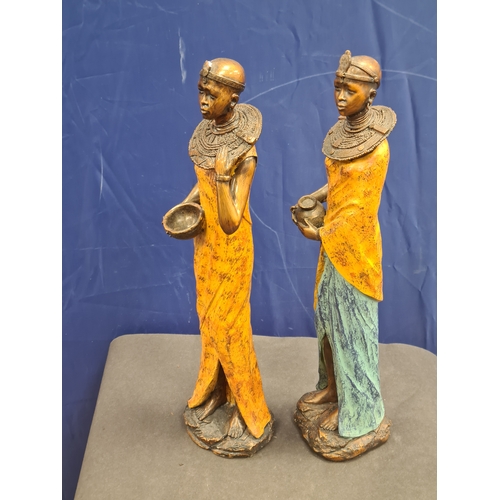 534 - A Pair of tall cast resin African lady figures in decorative native costume. One AF on head band, bo... 