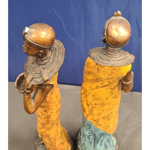 534 - A Pair of tall cast resin African lady figures in decorative native costume. One AF on head band, bo... 